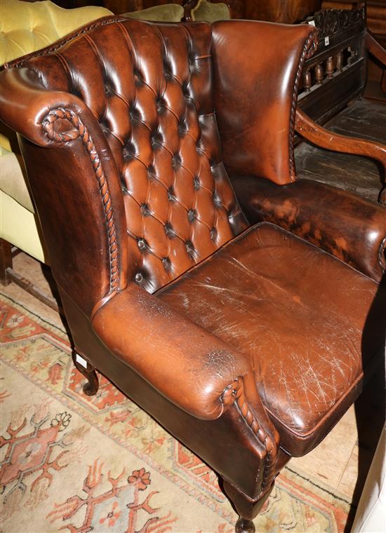Brown leather wing armchair